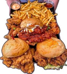 a tray filled with chicken sandwiches and french fries