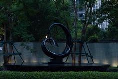 a sculpture in the middle of a park at night