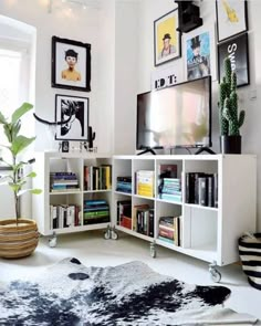 a living room filled with furniture and pictures on the wall