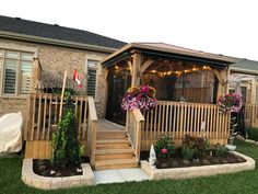 a house with flowers and lights on the porch