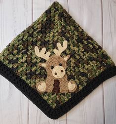 a crocheted square with a deer on it