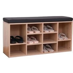 a wooden shoe rack with shoes on it and a black seat pad in the middle