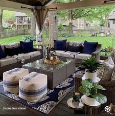 an outdoor living area with couches, tables and chairs