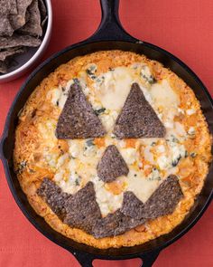 a skillet filled with cheese and tortilla chips