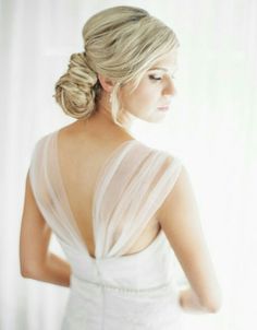 a woman in a wedding dress looking back