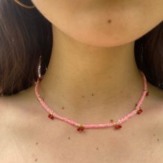 Introducing our sweet and playful pink beaded choker, featuring adorable cherries all around! Handcrafted with love, this choker is the perfect accessory for anyone who loves to add a touch of whimsy to their outfit. The choker features a delicate beaded design in shades of pink, with alternating beaded bright red cherries with green stems creating a charming and delightful look. This choker is also incredibly comfortable to wear, with a soft and lightweight construction that won't weigh you down. Whether you're dressing up for a summer picnic or adding a playful touch to your everyday look, this beaded choker is sure to turn heads and make a statement. Perfect for those who love kitschy and cute accessories, this choker is a must-have for any fashion-forward individual. It also makes a wo Cherry Beaded Necklace Tutorial, Trendy Pink Choker With Tiny Beads, Trendy Pink Tiny Beads Choker, Trendy Pink Choker With Round Beads, Trendy Pink Beaded Choker, Dainty Pink Beaded Necklaces With Heart Beads, Dainty Pink Beaded Necklace With Heart Beads, Trendy Pink Beaded Choker Necklaces, Pink Beaded Dainty Choker