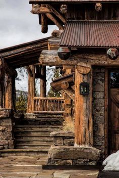 an old log cabin with steps leading up to it