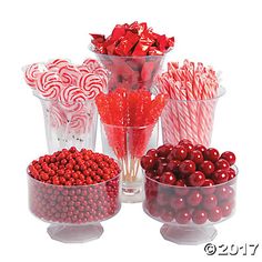 candy canes and candies in glass containers on a white background with red berries