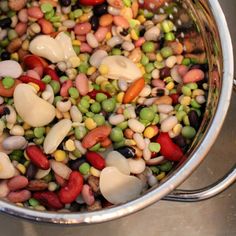 a pot filled with lots of different colored beans