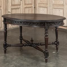 an ornately carved wooden table in front of two doors