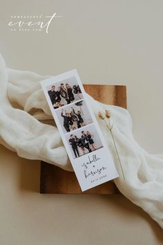 the wedding album is laying on top of a wooden block with white fabric around it