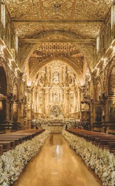 the interior of an old church decorated with flowers