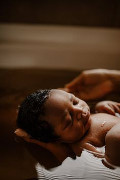 a young boy is taking a bath in the tub