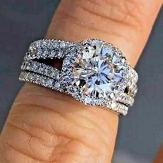 a woman's hand with a diamond ring on it