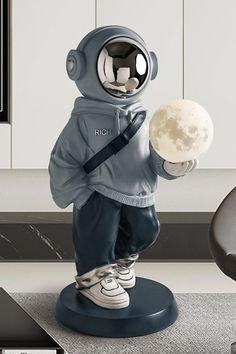 a statue of a man in an astronaut suit holding a ball