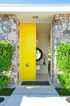 a yellow door is in the entry way