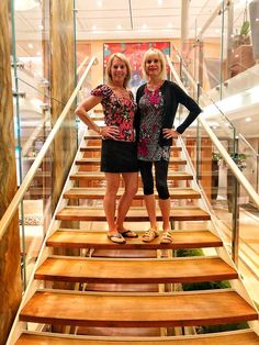 two women are standing on some wooden stairs