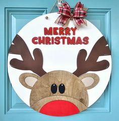 a christmas door hanger with a reindeer face on it