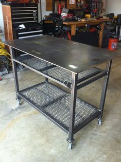 a metal workbench in a garage with tools on the table and other items