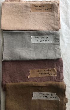 four different colored linens with some writing on one side and the other half in brown