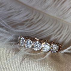 three diamond rings sitting on top of a feather