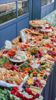 a long table filled with lots of different types of food on top of each other