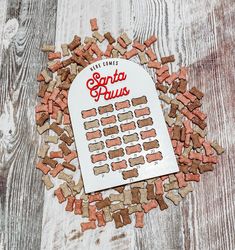 a pile of red and brown dog food sitting on top of a wooden floor next to a sign