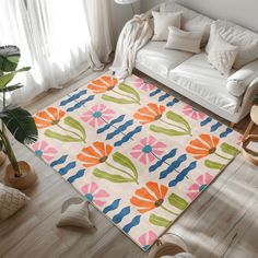 a living room with a white couch and colorful rug