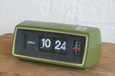 an alarm clock sitting on top of a wooden table