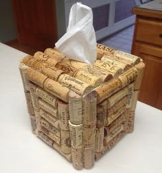 a tissue box made out of wine corks is sitting on a counter top with a napkin in it