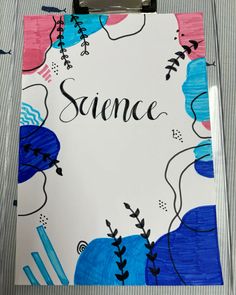 a clipboard with the word science written on it next to some pens and pencils