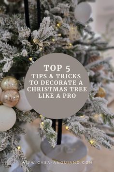 a decorated christmas tree with white and gold ornaments on it, the words top 5 tips to decorate a christmas tree like a pro