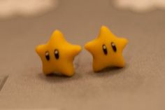 two little yellow stars sitting on top of a laptop