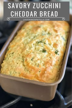 a loaf of savory zucchini cheddar bread in a baking pan