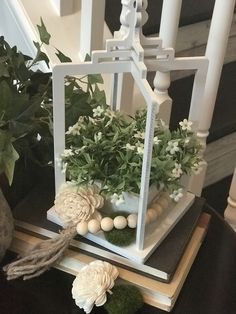 a planter with flowers and eggs in it on top of a table next to some stairs