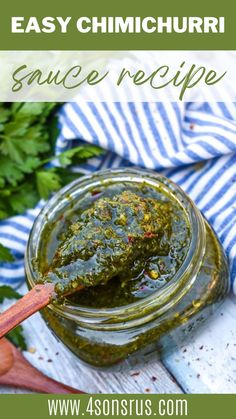 a jar filled with homemade pesto sauce on top of a wooden spoon next to parsley