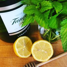 there is a bottle of wine next to some lemons and a fork on the table