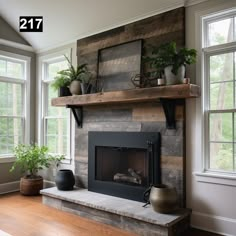 a living room with a fire place and potted plants on top of the mantle