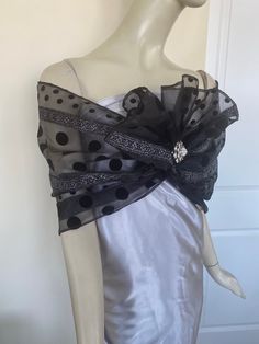 Elegant women's black organdy scarf with flocking. Silver accent. A sparkly accessory for special occasions. Drape on the neck as a traditional tie scarf or wrap around the shoulders as an elegant shawl. Semi sheer. Dry clean. ** Brooch not included. Organdy Fabric, Printed Beach Dresses, Sparkly Accessories, Elegant Shawl, Formal Tops, Summer Tunics, Reversible Scarf, Sheer Scarf, Tie Scarf