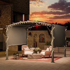 a patio covered in white lights and furniture