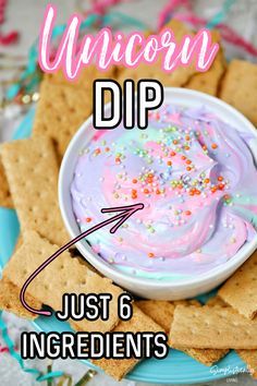 unicorn dip with sprinkles in a bowl surrounded by crackers