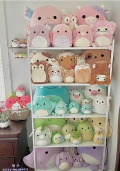 a shelf filled with lots of stuffed animals on top of it's sides and the words squishmallows above them