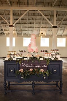 a table topped with a cake and lots of cupcakes on top of it