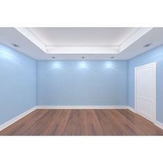 an empty room with blue walls and wooden floors is shown in this image, there are lights on either side of the door