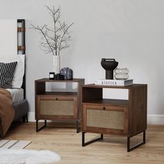 two end tables sitting on top of a hard wood floor next to a white bed