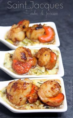 three small white dishes filled with food on top of a black tablecloth covered surface