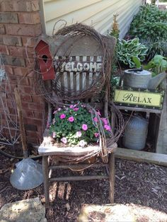 an old chair is sitting outside with flowers in it