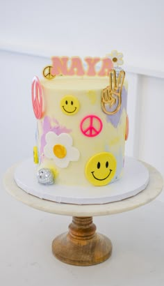 a cake with smiley faces and peace signs on it