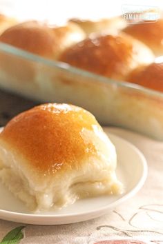 a close up of a piece of bread on a plate near a casserole dish