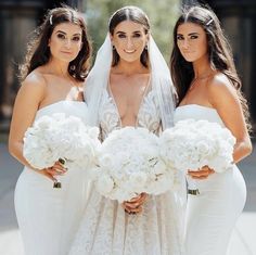 three beautiful women in white dresses holding bouquets